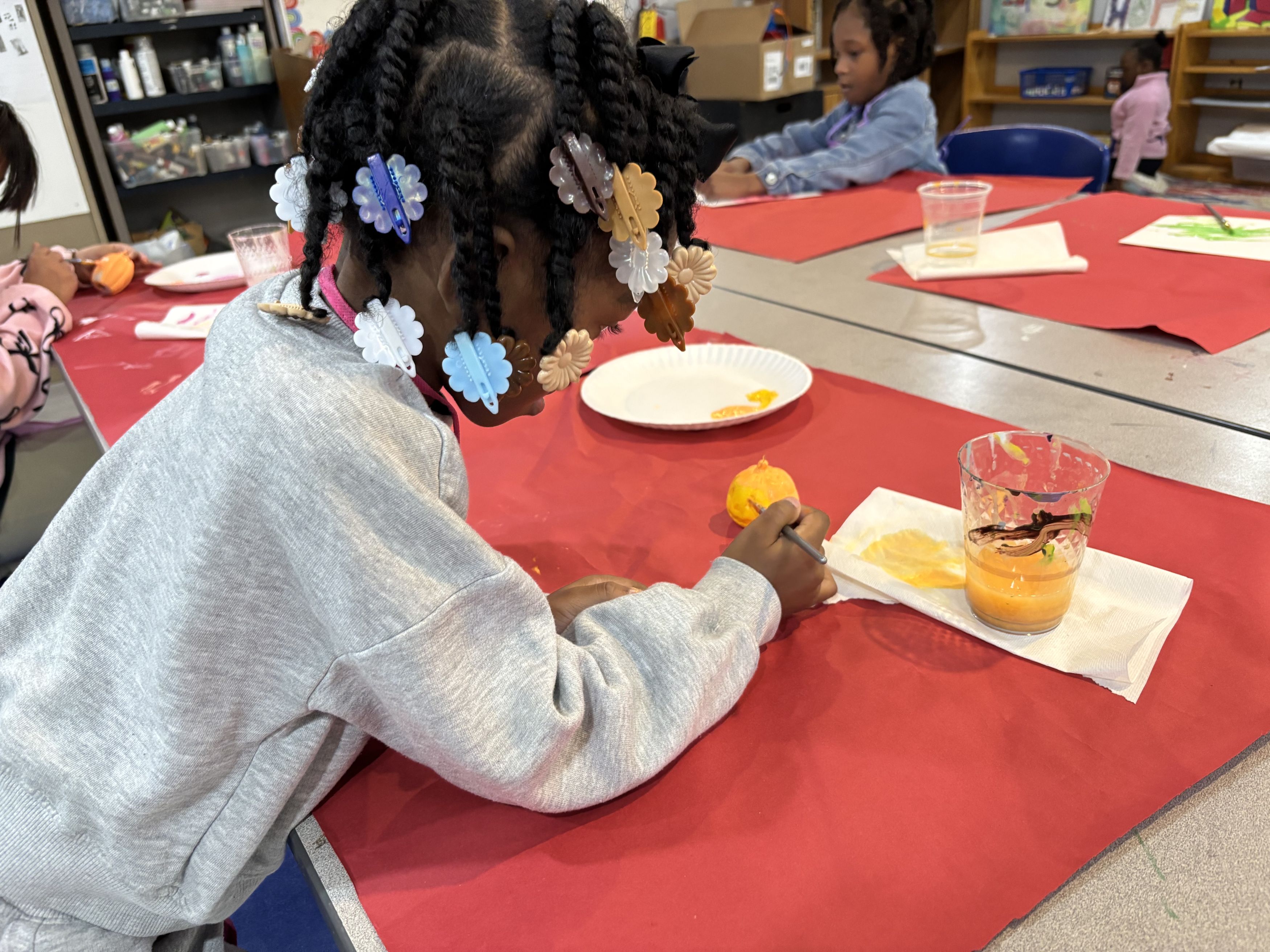 girl painting pumpkin
